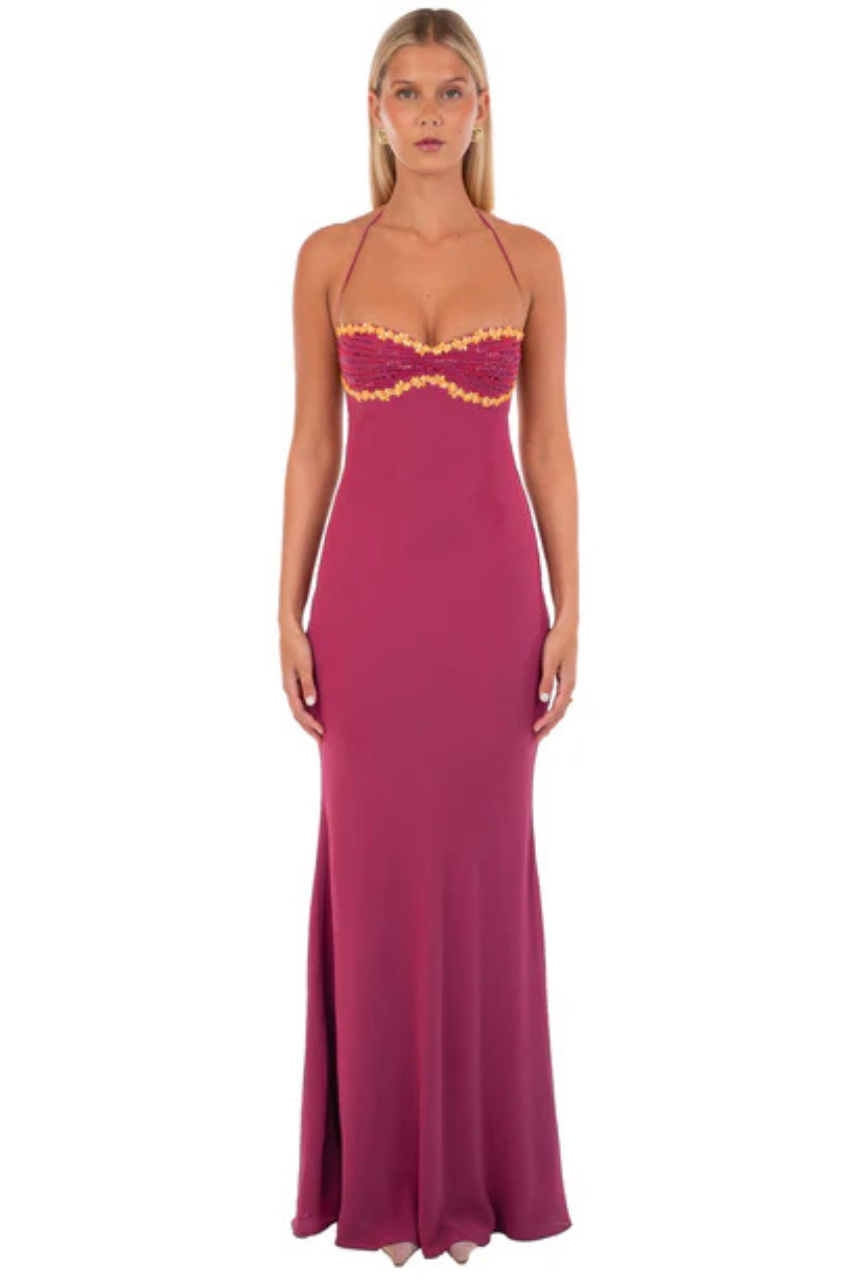 Woman wearing a wine coloured evening gown with gold accents perfect for graduation